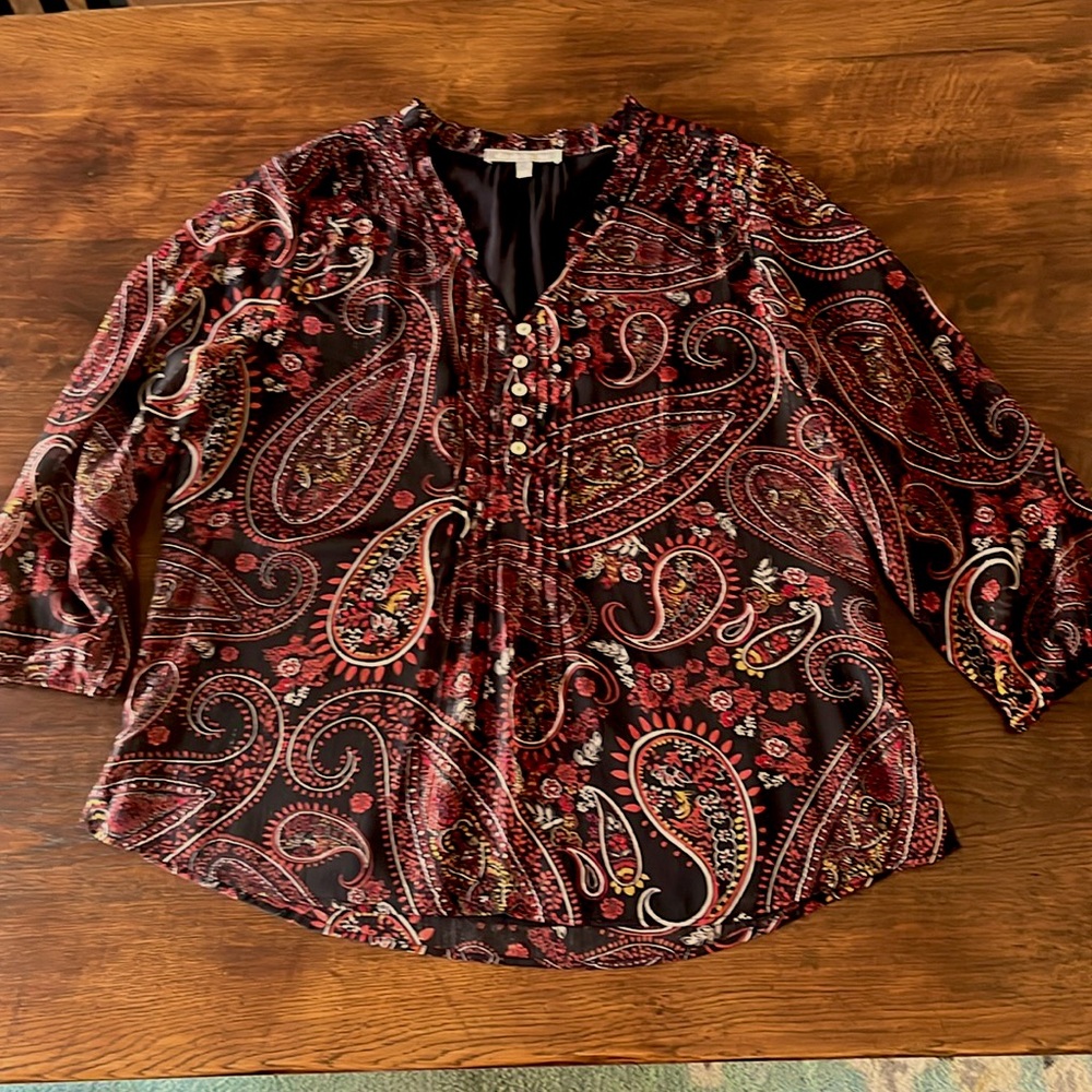 3/4 sleeve lined blouse with ruffle, tuck, and button detailing.Size L